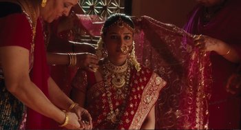 Movie still from “Eat Pray Love” (2010), directed by Ryan Murphy – A woman in a red sari getting ready for a wedding; Medium shot, Over the shoulder angle
