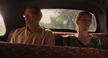 Movie still from “Eat Pray Love” (2010), directed by Ryan Murphy – A man and a woman sitting in the back of a car; Medium shot, Over the shoulder angle