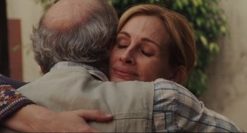 Movie still from “Eat Pray Love” (2010), directed by Ryan Murphy – An older man and woman hugging each other; Close Up shot, Over the shoulder angle