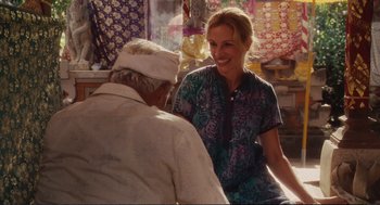 Movie still from “Eat Pray Love” (2010), directed by Ryan Murphy – A woman talking to an older man in a store; Medium shot, Over the shoulder angle