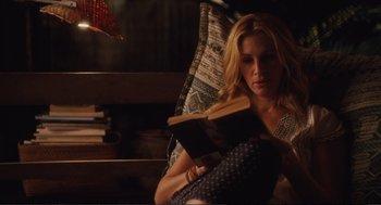 Movie still from “Eat Pray Love” (2010), directed by Ryan Murphy – A woman sitting in a chair reading a book; Medium shot, High angle