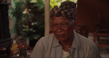 Movie still from “Eat Pray Love” (2010), directed by Ryan Murphy – An older man wearing a turban is sitting in a room; Close Up shot, Over the shoulder angle