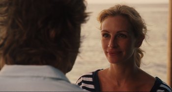 Movie still from “Eat Pray Love” (2010), directed by Ryan Murphy – A woman is looking at a man in front of a body of water; Close Up shot, Over the shoulder angle