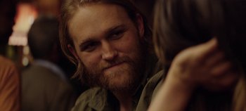 Movie still from “Black Mirror” (2011), created by Charlie Brooker – A person with long hair and a beard; Close Up shot, Over the shoulder angle