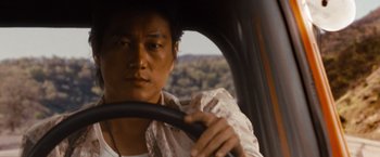 Movie still from “Fast & Furious” (2009), directed by Justin Lin – A man sitting in the driver's seat of a car; Close Up shot, Over the shoulder angle