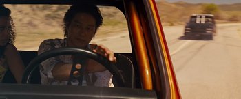 Movie still from “Fast & Furious” (2009), directed by Justin Lin – A man driving a car on a road; Close Up shot, Over the shoulder angle