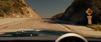 Movie still from “Fast & Furious” (2009), directed by Justin Lin – A view from a car of a mountain road; Wide shot, High angle