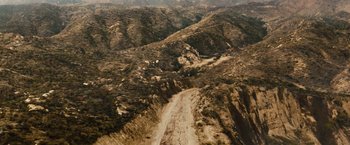 Movie still from “Fast & Furious” (2009), directed by Justin Lin – An aerial view of a dirt road in the middle of the desert; Extreme Wide shot, High angle