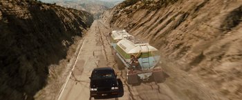 Movie still from “Fast & Furious” (2009), directed by Justin Lin – A truck driving down a road next to a car; Extreme Wide shot, High angle