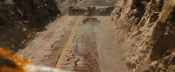 Movie still from “Fast & Furious” (2009), directed by Justin Lin – A truck driving down a road near a cliff; Extreme Wide shot, High angle
