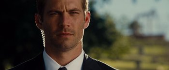 Movie still from “Fast & Furious” (2009), directed by Justin Lin – A man in a suit and tie; Close Up shot, Over the shoulder angle