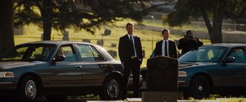 Movie still from “Fast & Furious” (2009), directed by Justin Lin – A couple of men standing next to each other in a cemetery; Wide shot, Over the shoulder angle
