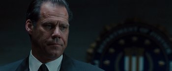 Movie still from “Fast & Furious” (2009), directed by Justin Lin – A man in a suit and tie; Close Up shot, Low angle