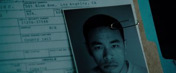 Movie still from “Fast & Furious” (2009), directed by Justin Lin – A picture of a man's face with a pair of glasses hanging off of it; Extreme Close Up shot, Overhead angle