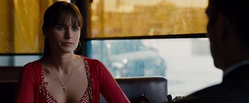 Movie still from “Fast & Furious” (2009), directed by Justin Lin – A woman sitting in a chair in front of a window; Close Up shot, Over the shoulder angle