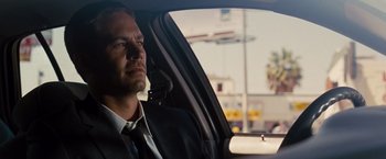 Movie still from “Fast & Furious” (2009), directed by Justin Lin – A man sitting in the back seat of a car; Close Up shot, Over the shoulder angle