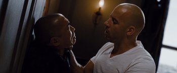 Movie still from “Fast & Furious” (2009), directed by Justin Lin – A man and a man in white shirt face each other; Close Up shot, Over the shoulder angle