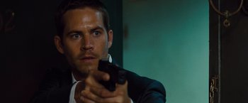 Movie still from “Fast & Furious” (2009), directed by Justin Lin – A man holding a gun in his hand; Close Up shot, Over the shoulder angle