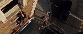 Movie still from “Fast & Furious” (2009), directed by Justin Lin – A group of people walking down a sidewalk; Extreme Wide shot, Overhead angle