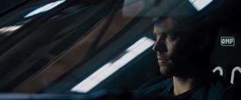 Movie still from “Fast & Furious” (2009), directed by Justin Lin – A person in a car looking out the window; Close Up shot, Over the shoulder angle