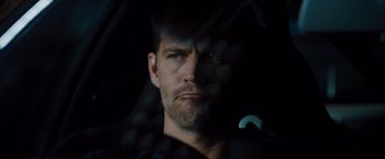 Movie still from “Fast & Furious” (2009), directed by Justin Lin – A person in a dark room; Close Up shot, Over the shoulder angle