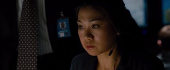 Movie still from “Fast & Furious” (2009), directed by Justin Lin – A woman wearing a headset in a dark room; Close Up shot, High angle