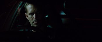 Movie still from “Fast & Furious” (2009), directed by Justin Lin – A person in a car in the dark; Close Up shot, Over the shoulder angle