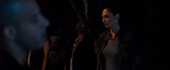 Movie still from “Fast & Furious” (2009), directed by Justin Lin – A man and a woman standing next to each other in the dark; Medium shot, Over the shoulder angle