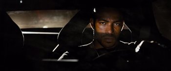 Movie still from “Fast & Furious” (2009), directed by Justin Lin – A person sitting in a car; Close Up shot, Over the shoulder angle