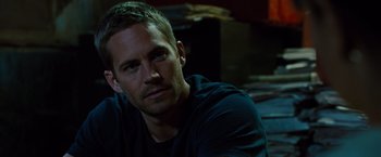 Movie still from “Fast & Furious” (2009), directed by Justin Lin – A man that is sitting in the dark; Close Up shot, Over the shoulder angle