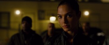 Movie still from “Fast & Furious” (2009), directed by Justin Lin – A woman in a leather jacket is looking at the camera; Close Up shot, Over the shoulder angle