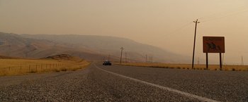 Movie still from “Fast & Furious” (2009), directed by Justin Lin – A car driving down the middle of a road; Extreme Wide shot, Low angle