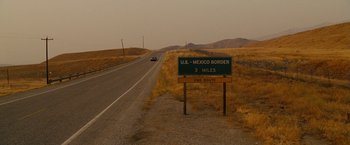 Movie still from “Fast & Furious” (2009), directed by Justin Lin – A sign on the side of the road that reads " u; Extreme Wide shot, High angle