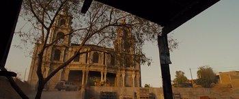 Movie still from “Fast & Furious” (2009), directed by Justin Lin – An old building with a large clock tower in the background; Extreme Wide shot, Low angle
