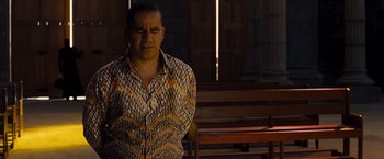 Movie still from “Fast & Furious” (2009), directed by Justin Lin – A man standing in front of a wooden bench with his eyes closed; Medium shot, Over the shoulder angle