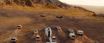 Movie still from “Fast & Furious” (2009), directed by Justin Lin – A group of cars and a helicopter in the middle of the desert; Extreme Wide shot, High angle