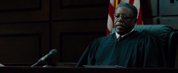 Movie still from “Fast & Furious” (2009), directed by Justin Lin – A man in a court room wearing a judge's robe; Close Up shot, Low angle