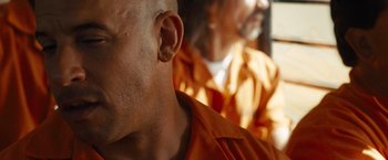 Movie still from “Fast & Furious” (2009), directed by Justin Lin – A person's ear and ear tag; Close Up shot, Over the shoulder angle