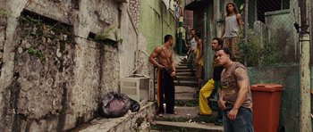Movie still from “Fast Five” (2011), directed by Justin Lin – A group of young men standing next to each other on a street; Wide shot, Low angle