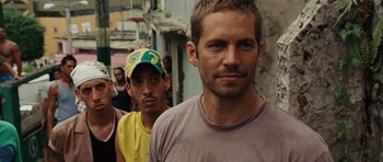 Movie still from “Fast Five” (2011), directed by Justin Lin – A man in a yellow hat and a man in a gray shirt; Close Up shot, Over the shoulder angle