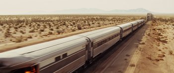 Movie still from “Fast Five” (2011), directed by Justin Lin – A train traveling down the tracks in the desert; Extreme Wide shot, High angle
