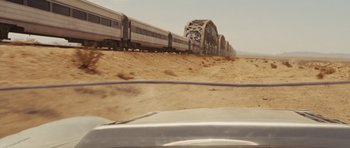 Movie still from “Fast Five” (2011), directed by Justin Lin – A train traveling on tracks through the desert; Close Up shot, Over the shoulder angle