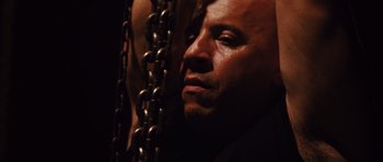 Movie still from “Fast Five” (2011), directed by Justin Lin – A person with chains around their neck; Close Up shot, High angle