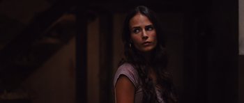 Movie still from “Fast Five” (2011), directed by Justin Lin – A beautiful woman with long dark brown hair and blue eyes; Close Up shot, Over the shoulder angle