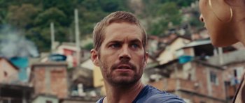 Movie still from “Fast Five” (2011), directed by Justin Lin – A person with a building in the background; Close Up shot, Over the shoulder angle