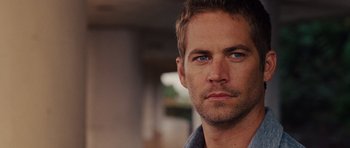 Movie still from “Fast Five” (2011), directed by Justin Lin – A person wearing a blue shirt; Close Up shot, Over the shoulder angle