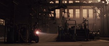 Movie still from “Fast Five” (2011), directed by Justin Lin – A man riding a motorcycle down a street at night; Wide shot, Low angle