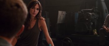 Movie still from “Fast Five” (2011), directed by Justin Lin – A beautiful woman standing in a room holding a can of soda; Medium shot, Over the shoulder angle