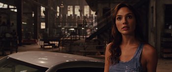 Movie still from “Fast Five” (2011), directed by Justin Lin – A beautiful young woman standing in front of a car; Close Up shot, Over the shoulder angle