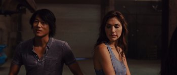 Movie still from “Fast Five” (2011), directed by Justin Lin – A woman standing next to a man in front of a wall; Close Up shot, Over the shoulder angle